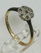 An 18ct gold and platinum diamond daisy ring, approximate weight 1.7g and size I.5