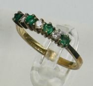 A 9ct gold emerald and diamond style ring, approximate size M.5