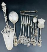 A selection of continental silver marked 800to include cake slice, claw sugar nips, pickle forks,