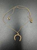 A 9ct gold horseshoe pendant and fine necklace AF (Approximate weight 2.2g)
