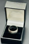 A hallmarked silver wedding style band, size Q
