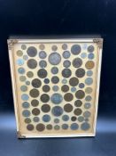 A framed selection of worldwide coins