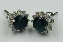 A pair of sapphire and diamond stud earrings