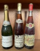 A bottle of Comte Neufchatel, a bottle of Muscat and a Las Campanas Rosade