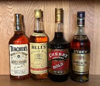 Four bottle of spirits, a Teachers and a Bells blended scotch whiskey and a Bols cherry brandy and