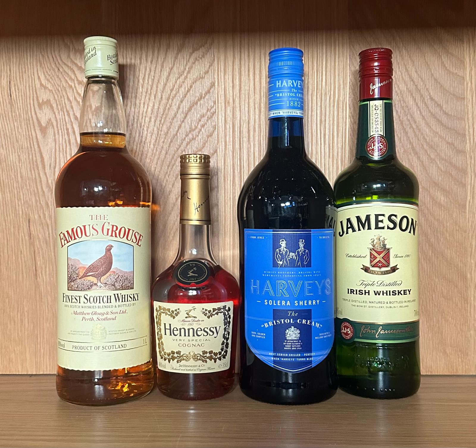 Four bottles of spirits, A Famous Groose scotch whiskey, a Haweys Bristol Cream, a Jamesons and a