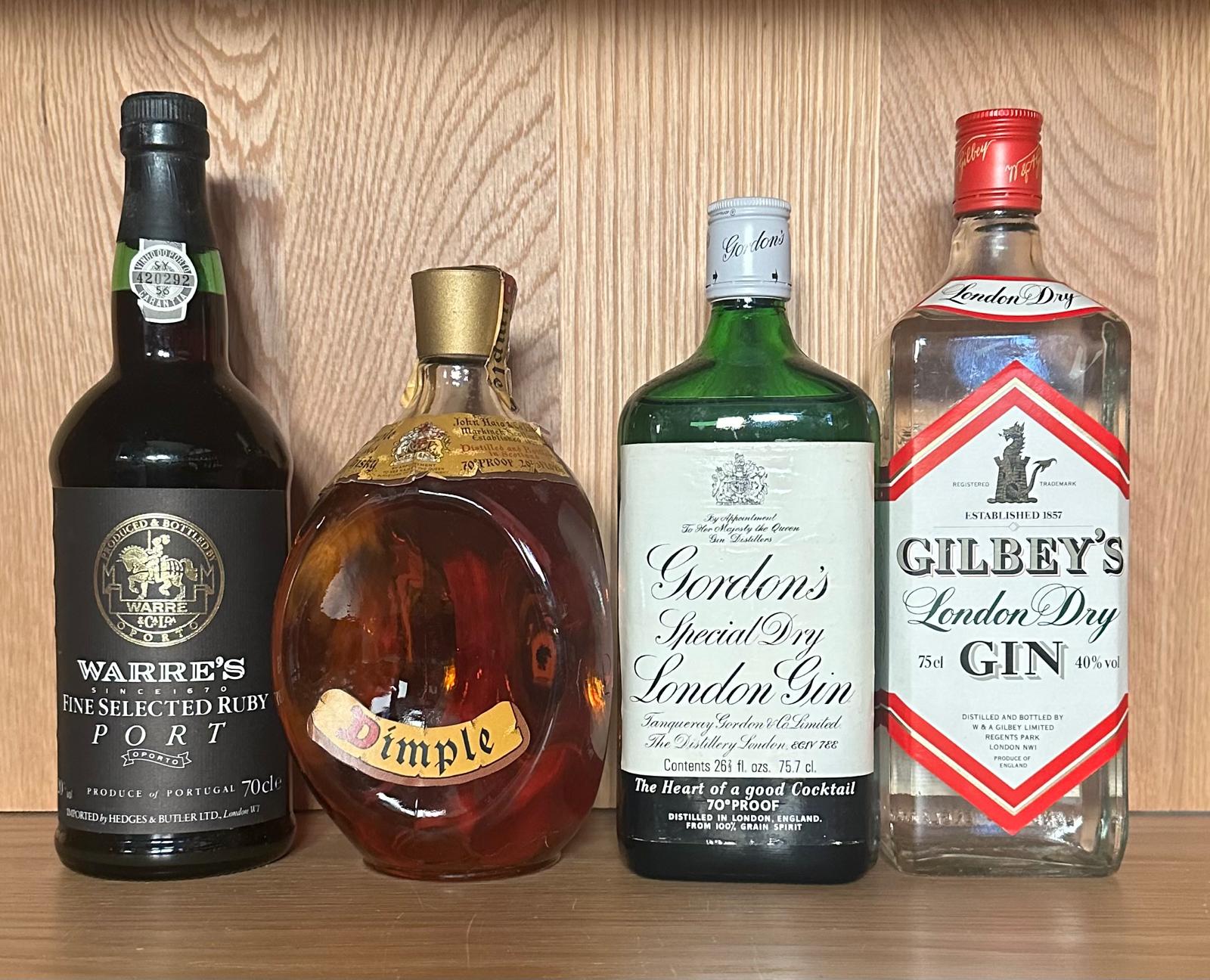 Four bottles of spirits, a Dimple blended scotch whiskey. a Gordons gin, a Gilbeys gin and a