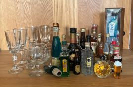 A selection of miniature and some glass ware to include Bombay sapphire, Prambuie and Asbach