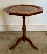 A red leather topped wine table on splayed legs (H47cm Dia36cm)
