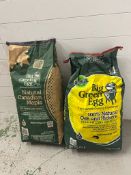 Two sealed bags of Big Green Egg charcoal, oak and hickory and Canadian maple