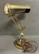 A brass bankers lamp with pierced shade