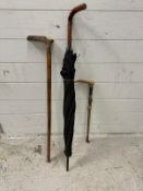 A selection of homed sticks and a vintage umbrella