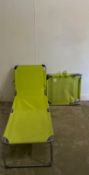 Two green collapsible sun loungers