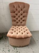 A pink button back bedroom chair