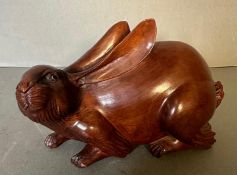 A carved wooden ornamental hare