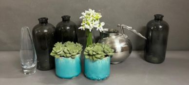 A selection of household decorative items to include glass bottles, an Art Deco style jug and faux