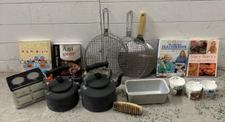 A selection of AGA related items to include kettles, toasting racks, mugs and books