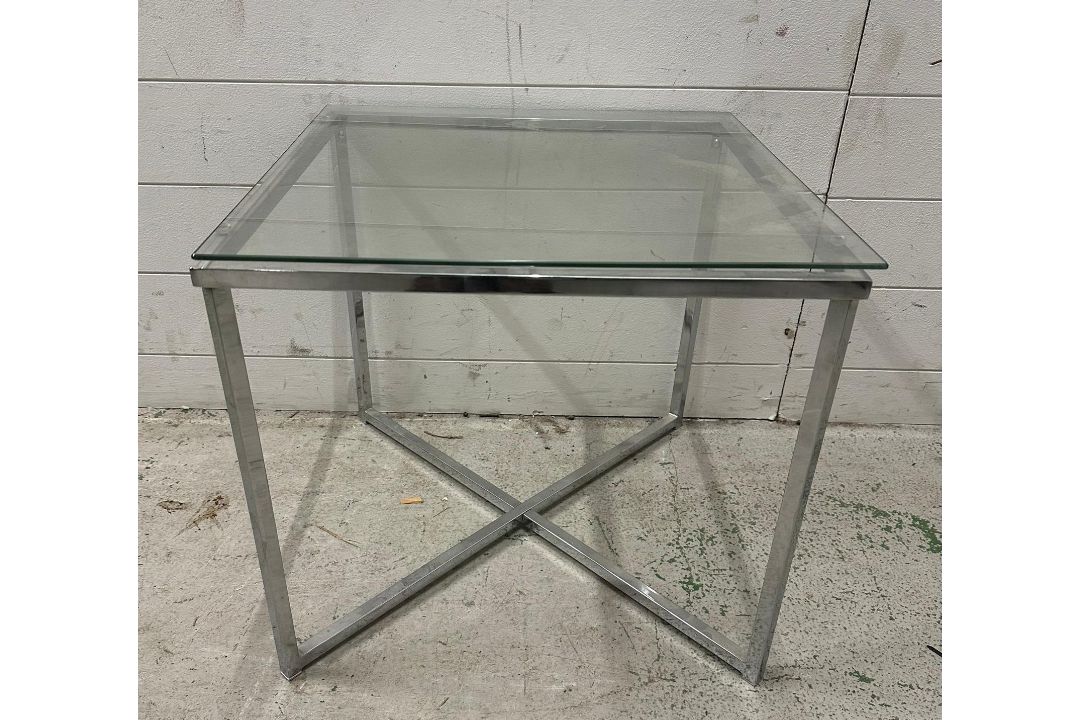 A glass topped side table on chrome X frame base (H45cm W50cm D50cm) - Image 1 of 3
