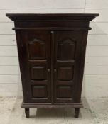 A two door mahogany cabinet on legs (H106cm W68cm D36cm)