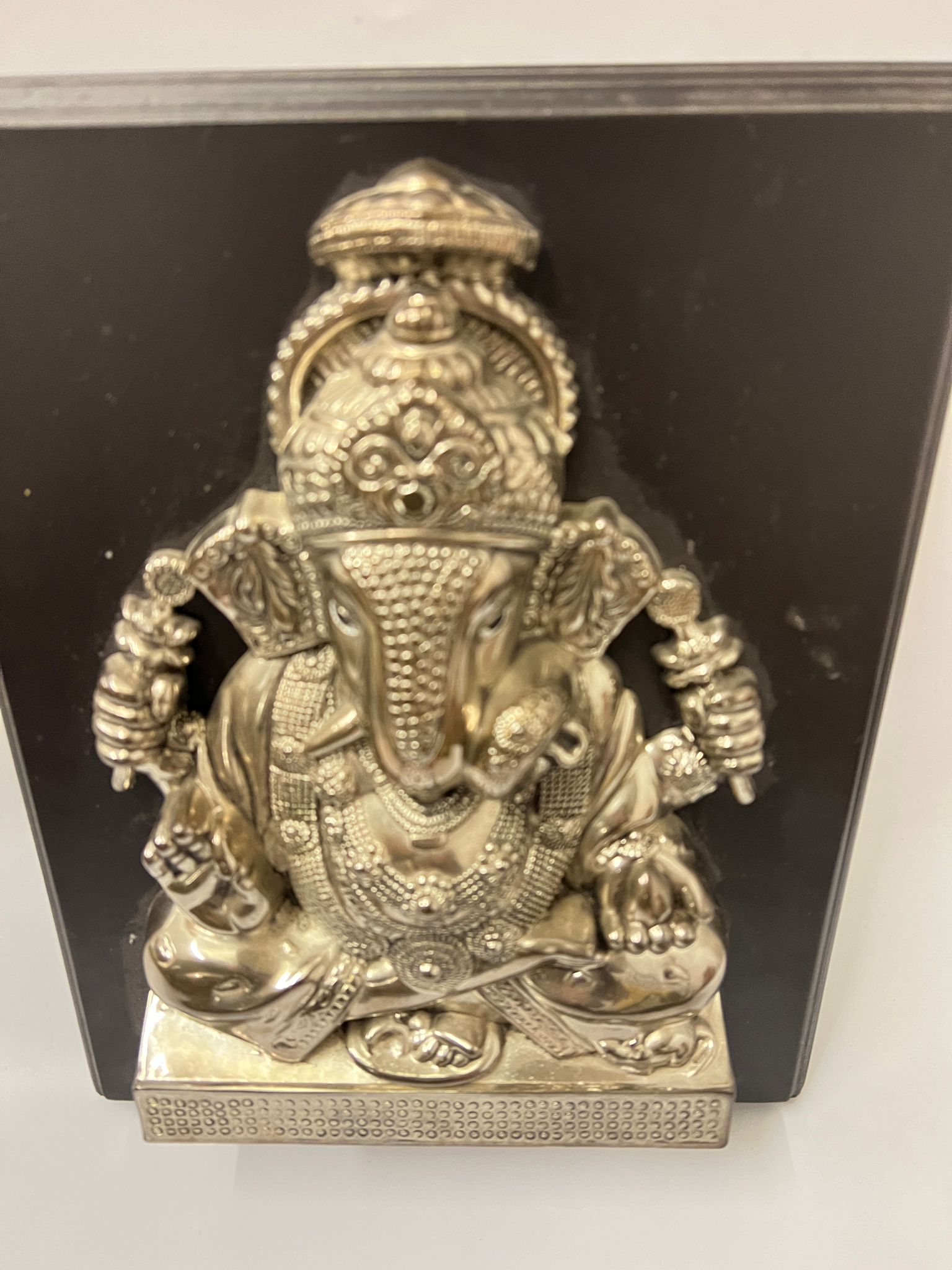 A white metal Ganesha repousse sculpture on board 31cm x 25cm - Image 2 of 3