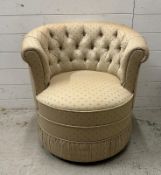 A button back tub chair in beige