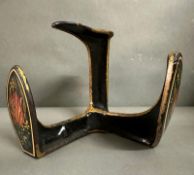 A decorative cast iron shoe last, hand painted with flowers