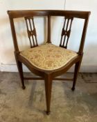 An Edwardian style corner chair with a floral upholstered seat