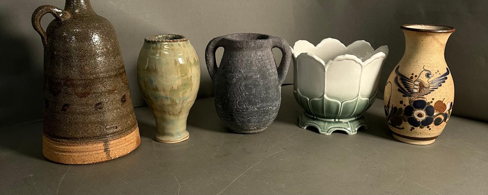 A selection of five glazed and unglazed vases in various styles