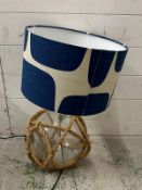 A glass marine themed table lamp with rope webbing