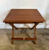 A folding slatted garden side table