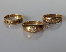A George V yellow gold gypsy ring with old-cut diamond, 0.10 carats; an Edwardian pearl and garnet 