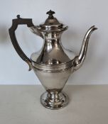 An Edwardian silver coffee pot, urn shaped with wood handle, hallmarked for Martin, Hall & Co