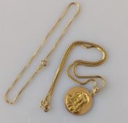 A yellow gold pendant chain (38 cm) with carved motif, both stamped 750, 14.3g
