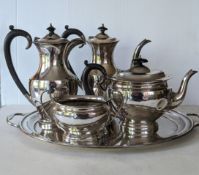 A mid-century four-piece silver tea and coffee service (creamer missing) with ebonised handles