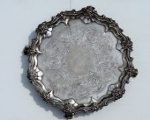 A Victorian silver circular tray with applied pie-crust border, elaborate C-scroll and floral carved