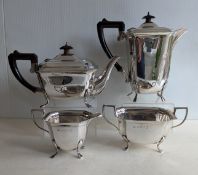 An Art Deco silver four-piece tea and coffee service with faceted decoration, ebonised handles 