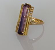 An amethyst dress ring in a yellow gold setting, the faceted tubular amethyst 25mm, stamped 750,