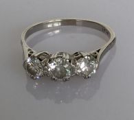 An Art Deco three-stone diamond ring on a platinum setting, each diamond approximately 0.25 carats