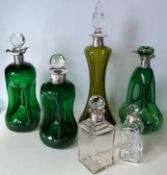 Three late Victorian/Edwardian green glass 'glug-glug' decanters with silver collars