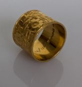 A 22ct yellow gold profusely etched scarf toggle or ring, 19mm internal diameter, 16mm H, hallmarked