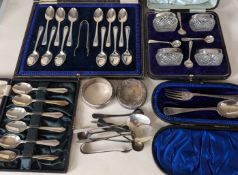 An Edwardian cased set of four silver-rimmed cut-glass salts with spoons