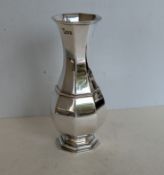 A George V silver octagonal vase of baluster form on a stepped base, hallmarked for William Comyns 