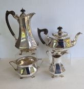 A George V silver teapot of octagonal form with wood handles raised on four trefid feet