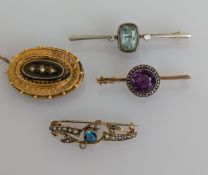 An assortment of four Victorian and Edwardian gem-set and seed pearl brooches, all stones and clasps