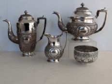 An early 20th century Indian silver three-piece tea and coffee service with a similar sugar bowl