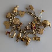 A 9ct yellow gold charm bracelet, all hallmarked, 63.5g