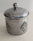 An early 20th century Chinese silver cylindrical box with domed lid, melon finial,