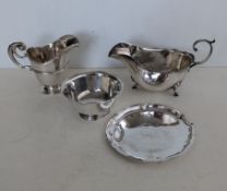A late Victorian silver cream jug with C-scroll handle, central girdle on a raised foot, hallmarked 