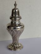 A late Victorian silver sugar caster of baluster form with urn finial and spiral twist design