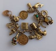 A 9ct yellow gold charm bracelet with an Edwardian mounted full and half gold sovereign, 1903, 1909